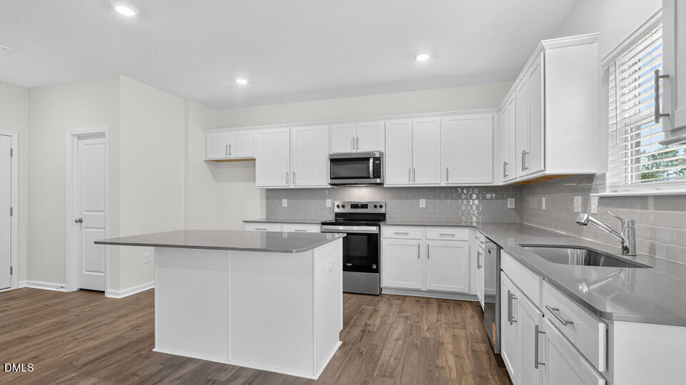 212 Calebs Cor Place Spring Lake, NC 28390 - Photo 11 of 45 a kitchen with stainless steel appliances granite countertop a sink and a stove