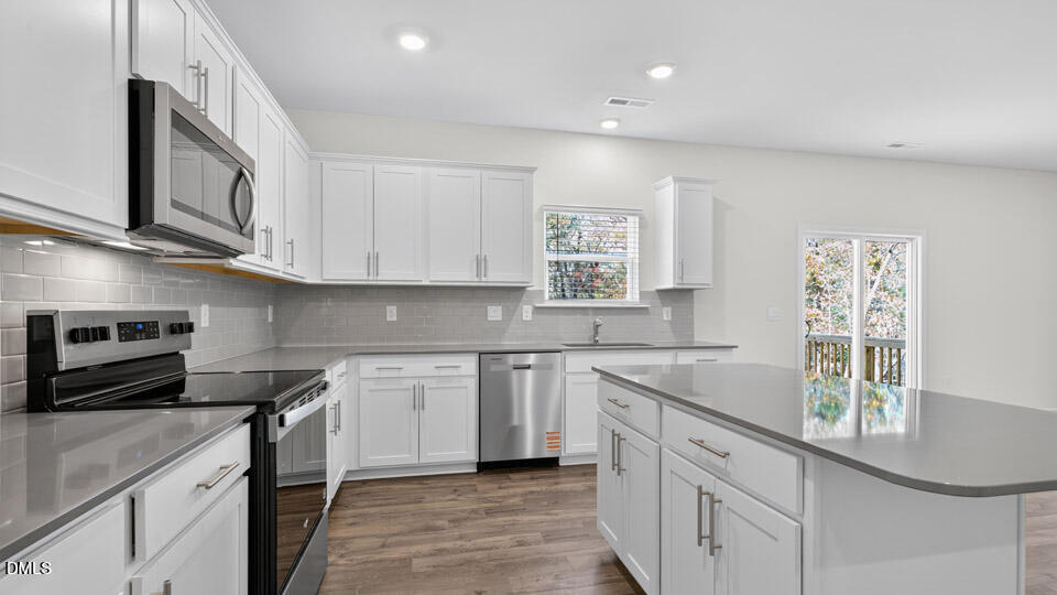212 Calebs Cor Place Spring Lake, NC 28390 - Photo 14 of 45 a kitchen with stainless steel appliances granite countertop a sink dishwasher a stove and a microwave oven with cabinets