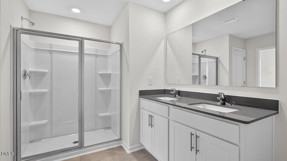 212 Calebs Cor Place Spring Lake, NC 28390 - Photo 30 of 45 a bathroom with a granite countertop sink and a mirror