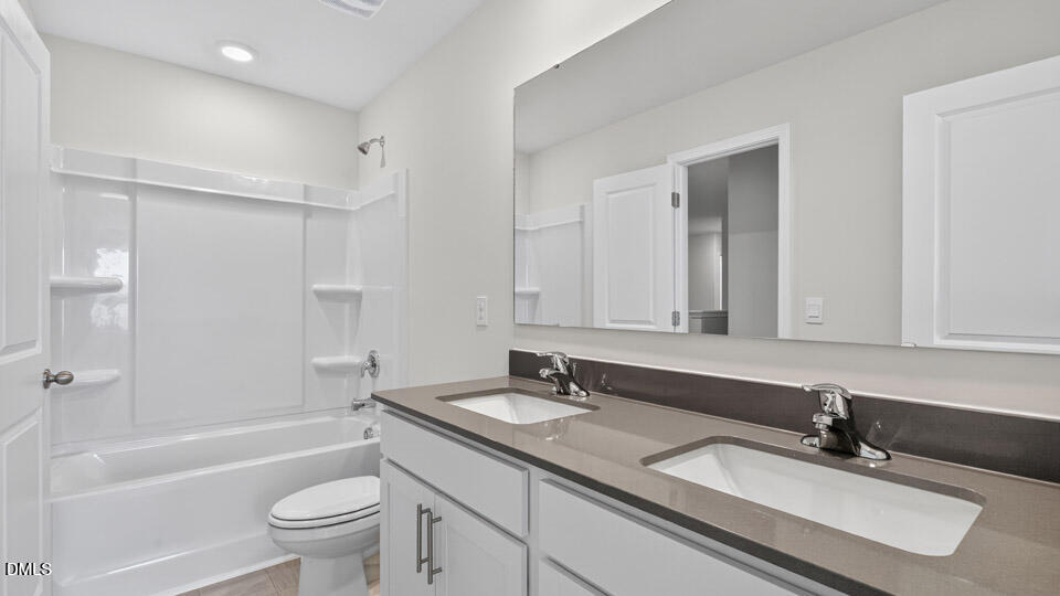 212 Calebs Cor Place Spring Lake, NC 28390 - Photo 31 of 45 a bathroom with a granite countertop sink double mirror bathtub shower and a bathtub