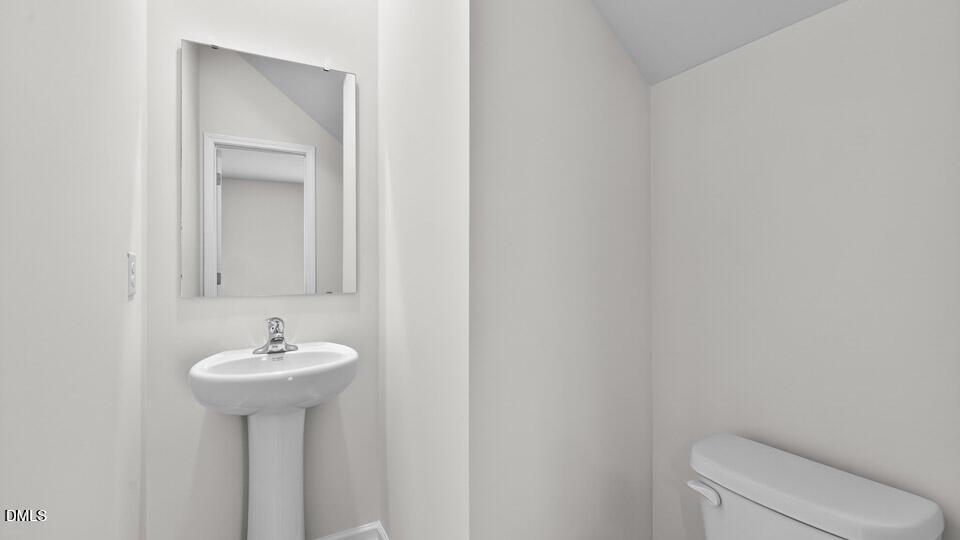 212 Calebs Cor Place Spring Lake, NC 28390 - Photo 33 of 45 a bathroom with a sink a toilet and mirror