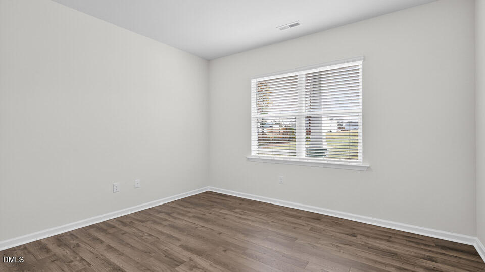 212 Calebs Cor Place Spring Lake, NC 28390 - Photo 6 of 45 an empty room with wooden floor and windows