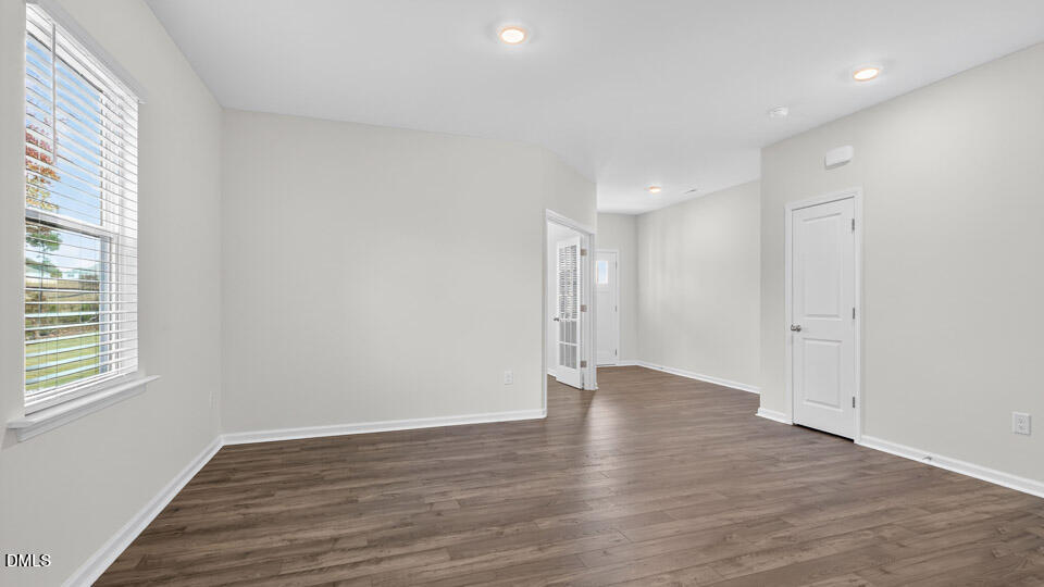 212 Calebs Cor Place Spring Lake, NC 28390 - Photo 7 of 45 a view of an empty room with wooden floor and a window