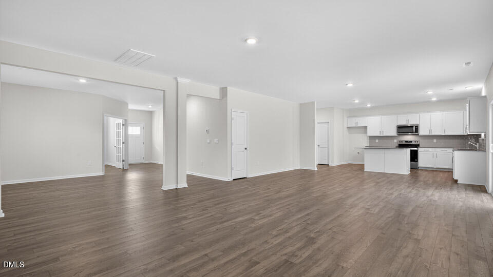 212 Calebs Cor Place Spring Lake, NC 28390 - Photo 9 of 45 a view of an empty room with wooden floor and kitchen