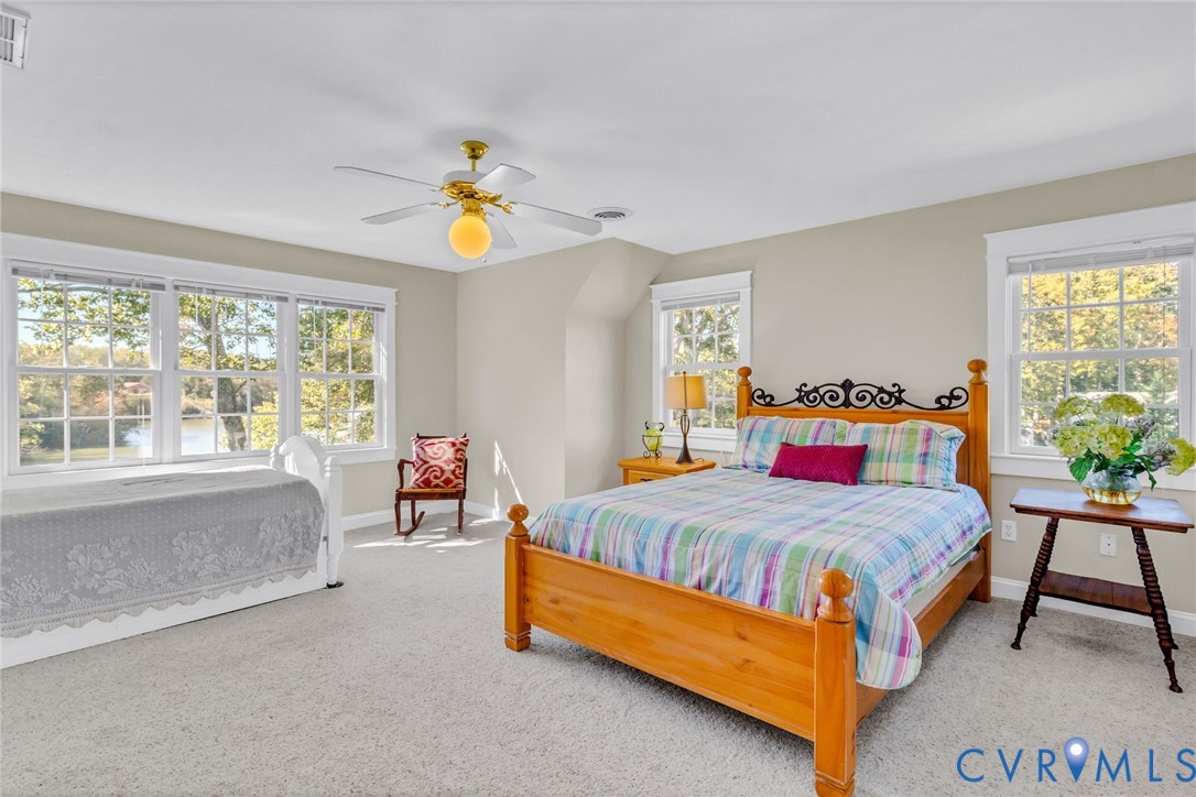 1248 Bancton Road Kinsale, VA 22488 - Photo 27 of 50 a bedroom with a bed and a chandelier