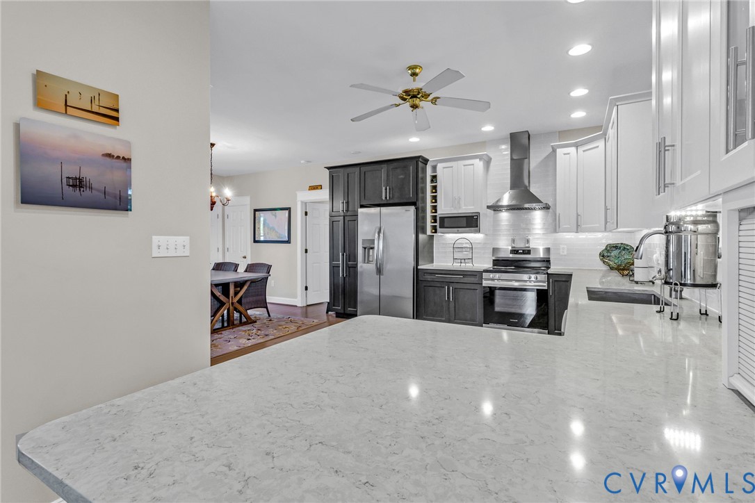 1248 Bancton Road Kinsale, VA 22488 - Photo 8 of 50 a kitchen with stainless steel appliances kitchen island granite countertop a refrigerator and microwave