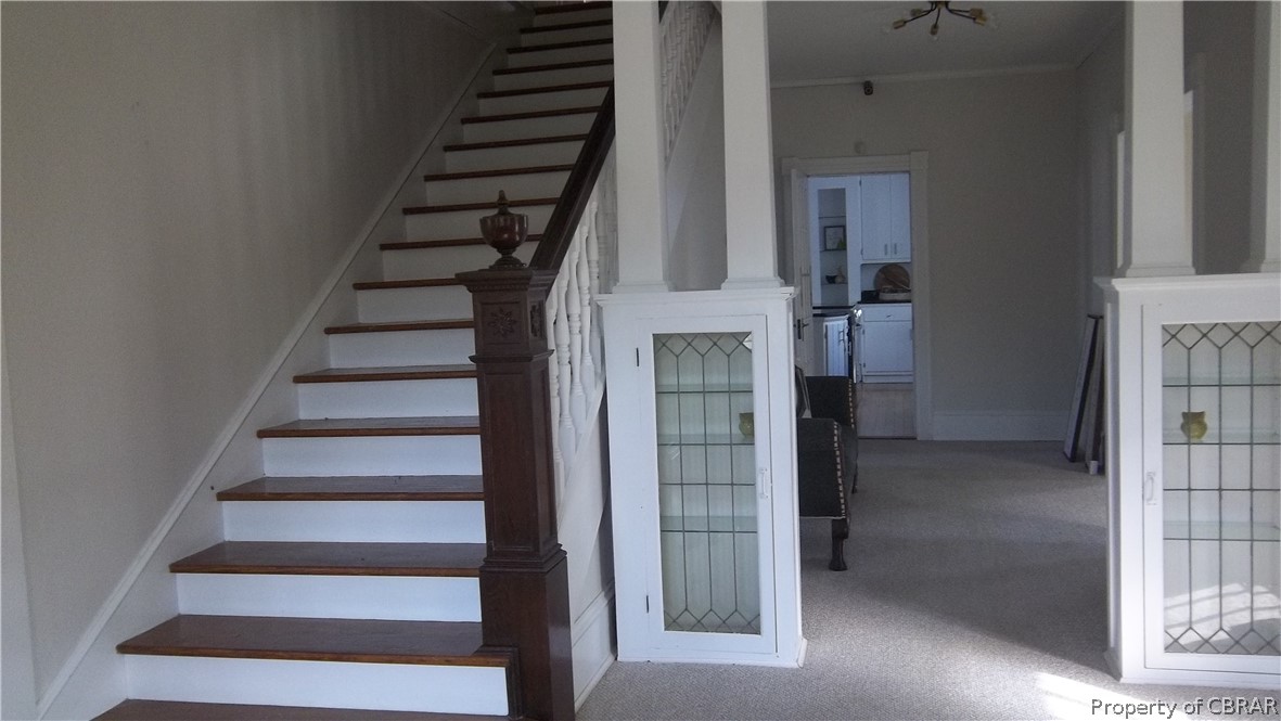 705 Greys Point Road Topping, VA 23169 - Photo 23 of 46 Staircase with ornamental molding and carpet flooring