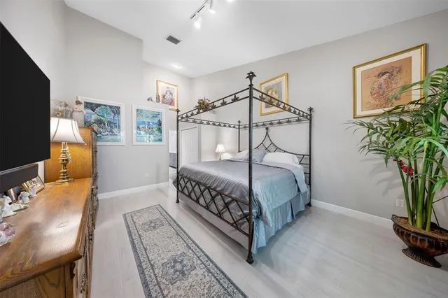 a bedroom with a bed and flat screen tv