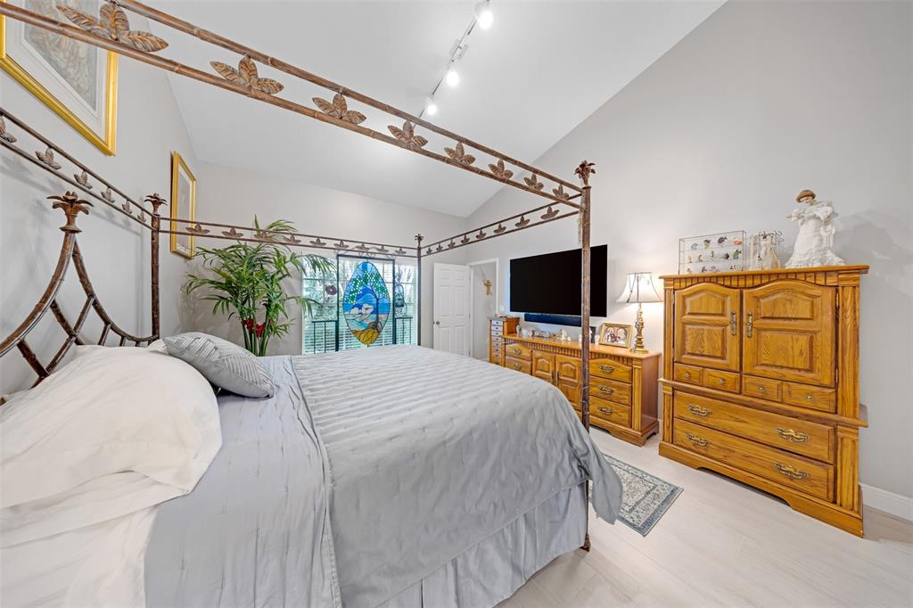 4115 Carriage Drive, Unit P2 Pompano Beach, FL 33069 - Photo 12 of 21 a bedroom with a bed and flat screen tv