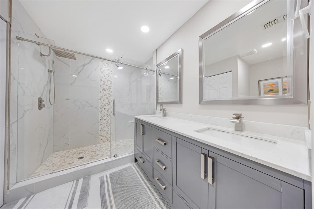 4115 Carriage Drive, Unit P2 Pompano Beach, FL 33069 - Photo 14 of 21 a bathroom with a shower sink and mirror