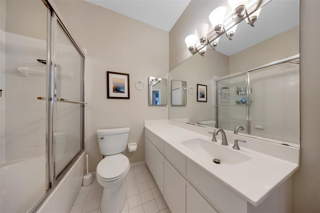 4115 Carriage Drive, Unit P2 Pompano Beach, FL 33069 - Photo 16 of 21 a bathroom with a toilet sink and mirror