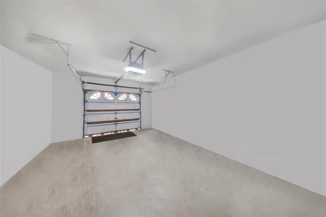 a view of a pathway with a tree in front of the house