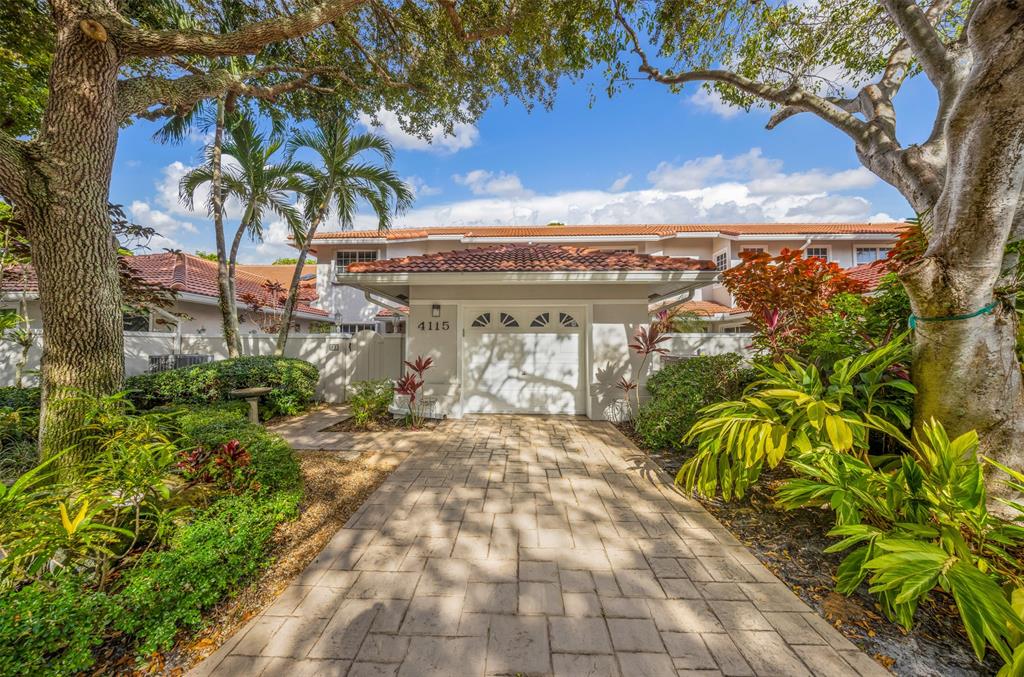 4115 Carriage Drive, Unit P2 Pompano Beach, FL 33069 - Photo 21 of 21 a view of a pathway with a tree in front of the house