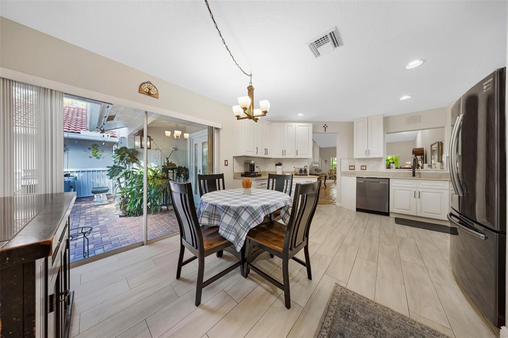 4115 Carriage Drive, Unit P2 Pompano Beach, FL 33069 - Photo 6 of 21 a view of a dining room and livingroom with furniture a rug a potted plant and a chandelier