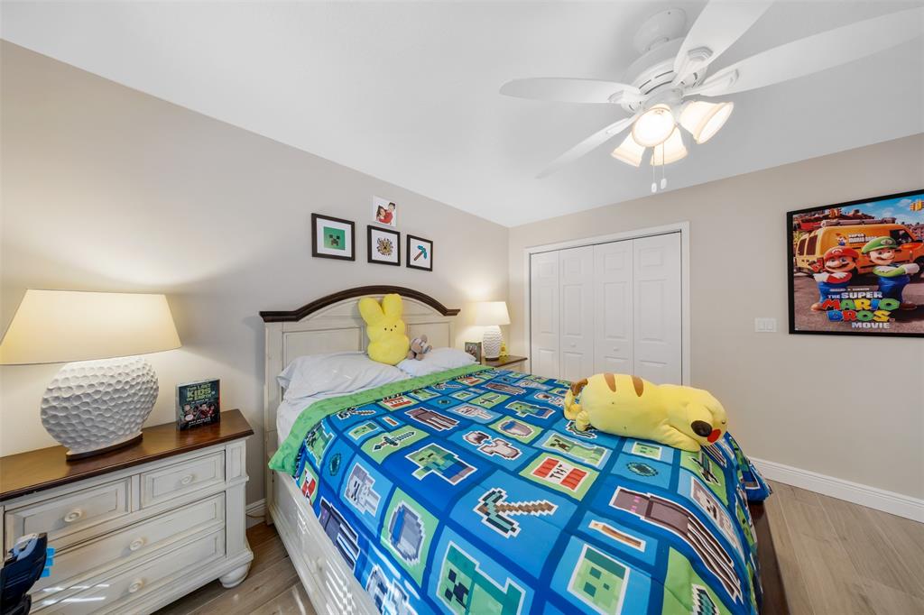 4115 Carriage Drive, Unit P2 Pompano Beach, FL 33069 - Photo 9 of 21 a bedroom with a bed and a lamp on dresser