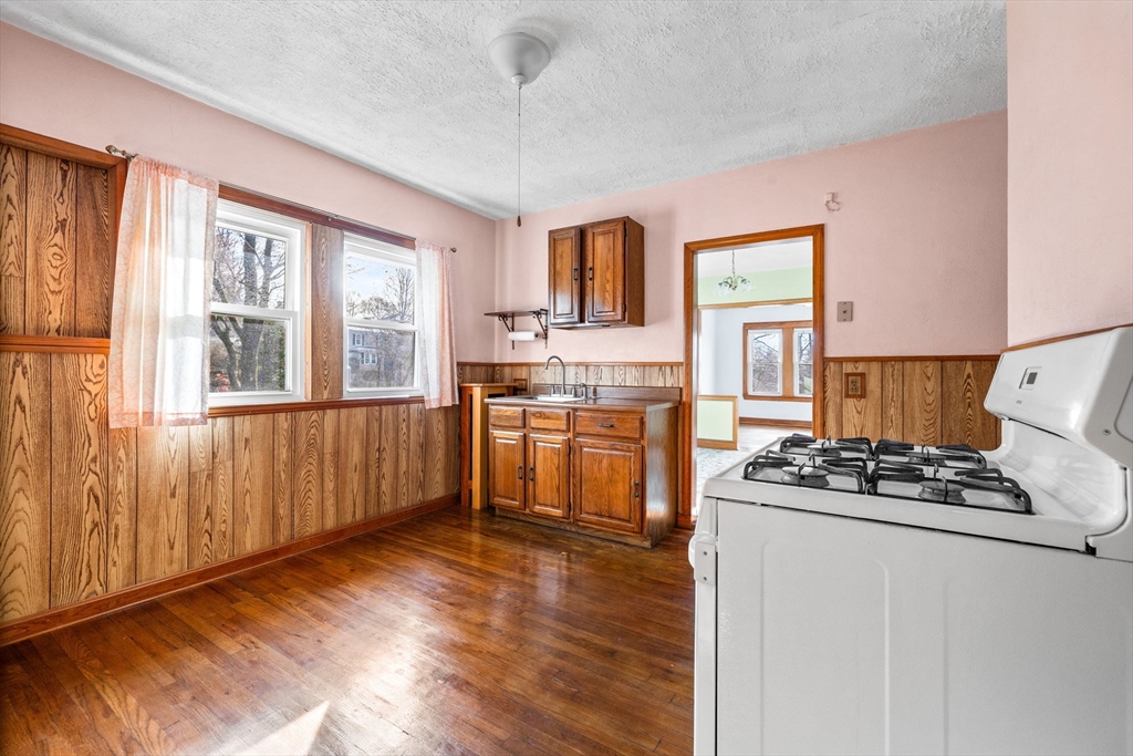 18-20 Pond Street Boston, MA 02136 - Photo 11 of 15 a kitchen with granite countertop a stove and a refrigerator