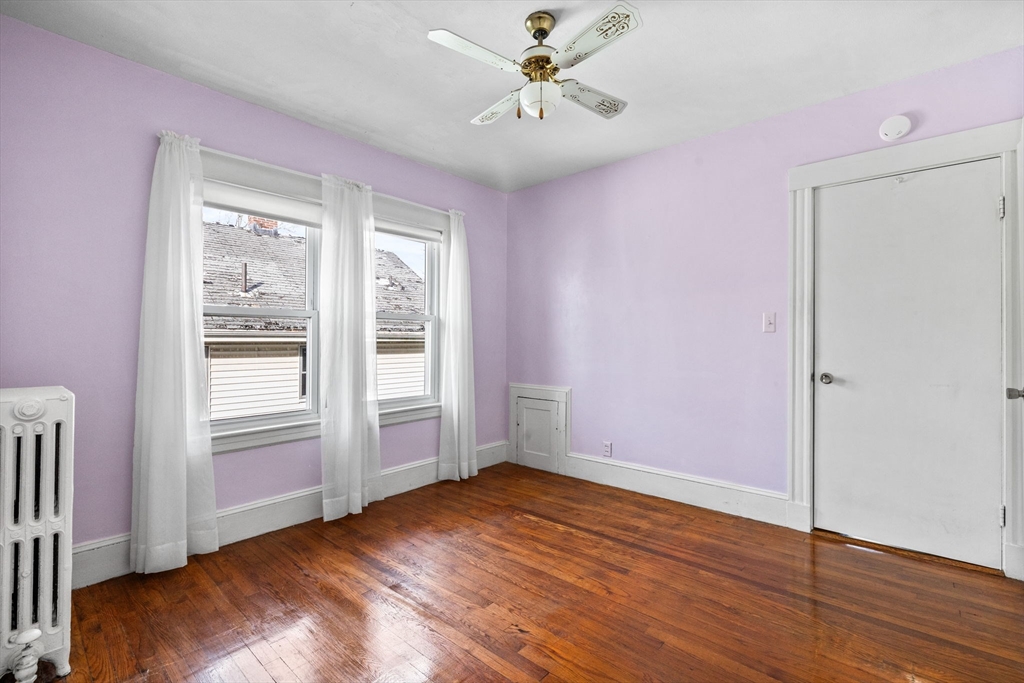 18-20 Pond Street Boston, MA 02136 - Photo 13 of 15 wooden floor in an empty room with a window