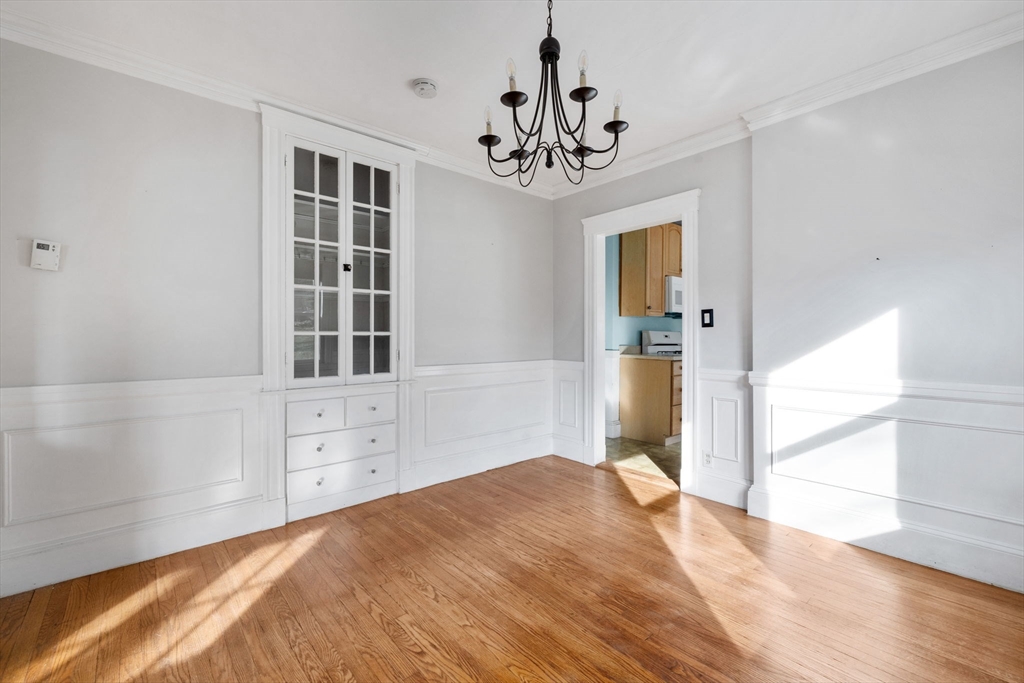 18-20 Pond Street Boston, MA 02136 - Photo 4 of 15 a bedroom with a large bed and a chandelier