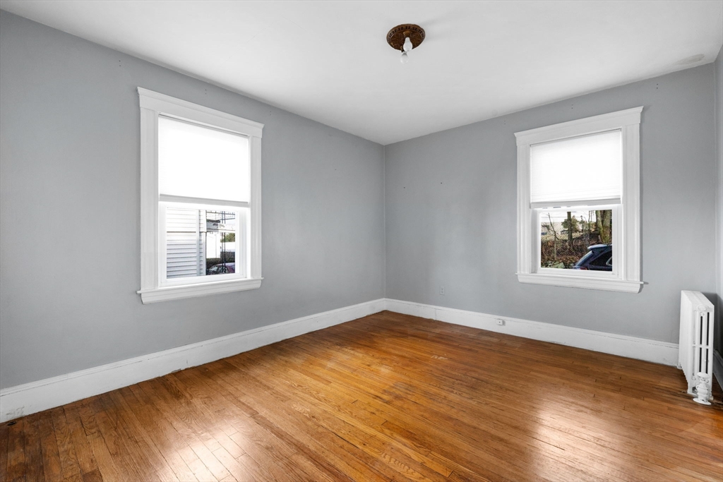 18-20 Pond Street Boston, MA 02136 - Photo 7 of 15 a view of an empty room with wooden floor and a window