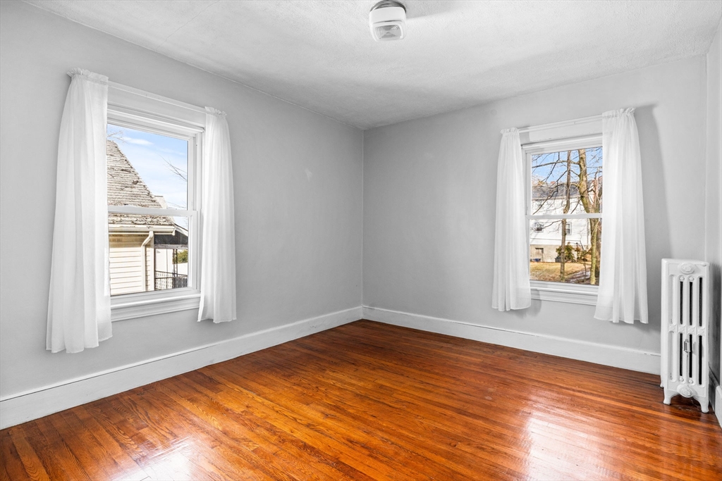 18-20 Pond Street Boston, MA 02136 - Photo 9 of 15 an empty room with wooden floor and windows