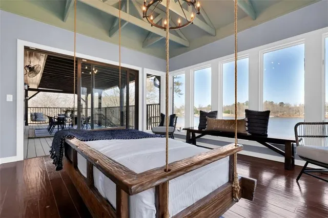 a kitchen with stainless steel appliances granite countertop a stove a refrigerator and a dining table with wooden floor