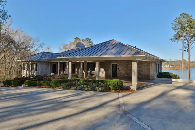 a front view of a house with a garden