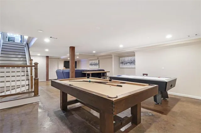 a room with furniture and pool table