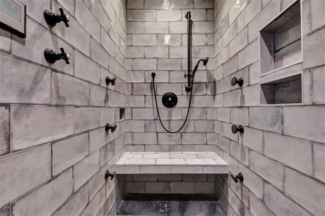 a bathroom with a bathtub and shower