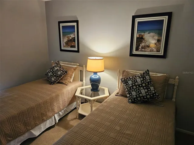 a bedroom with a bed and wall painting