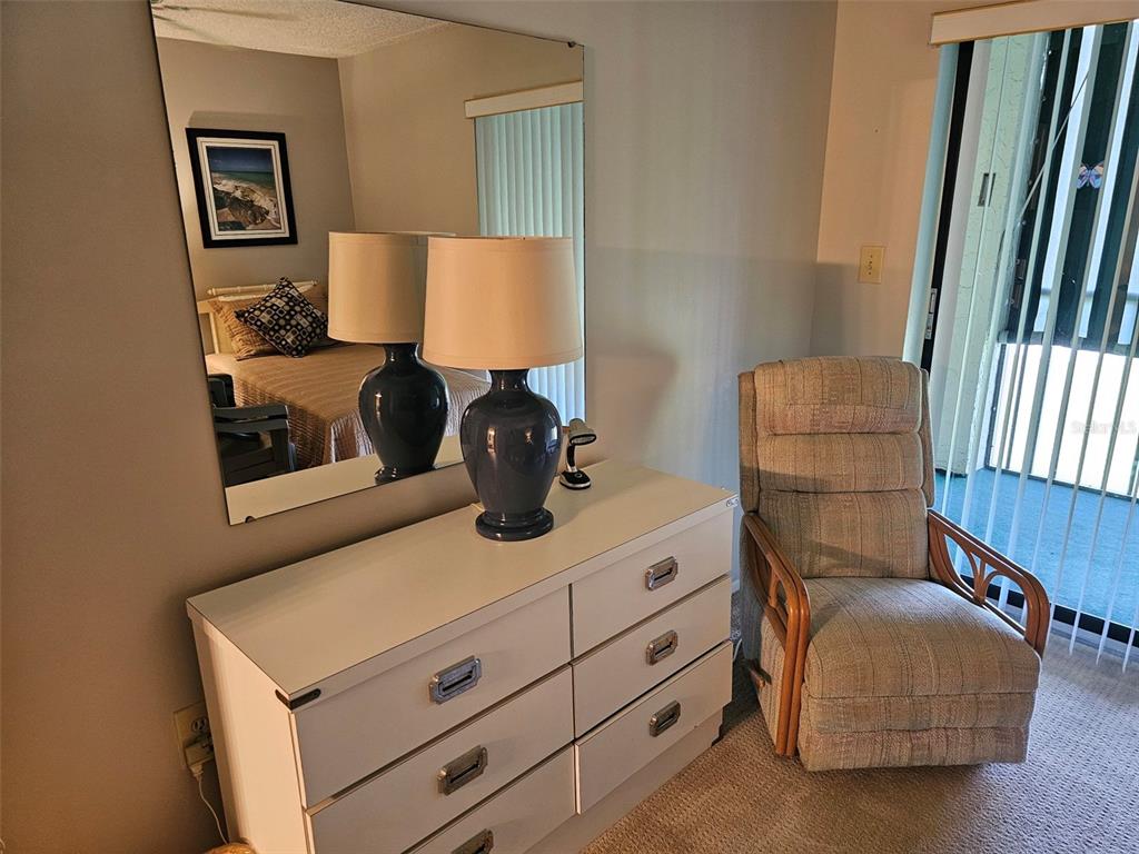 4119 61st Ave Terrace West, Unit 303 Bradenton, FL 34210 - Photo 15 of 22 a living room with furniture and a lamp