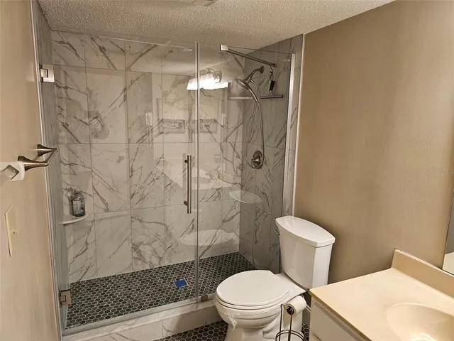 a bathroom with a toilet and a shower