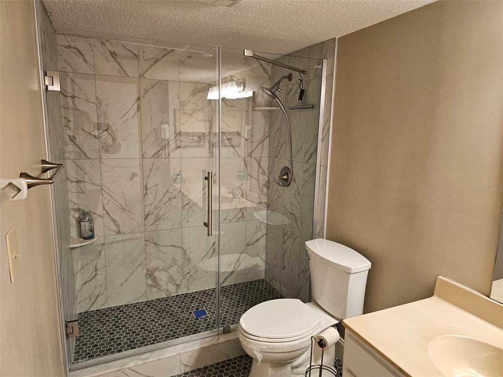4119 61st Ave Terrace West, Unit 303 Bradenton, FL 34210 - Photo 16 of 22 a bathroom with a toilet and a shower