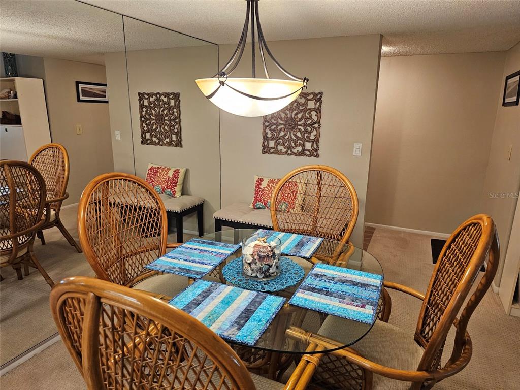 4119 61st Ave Terrace West, Unit 303 Bradenton, FL 34210 - Photo 2 of 22 a view of a dining room with furniture window and wooden floor