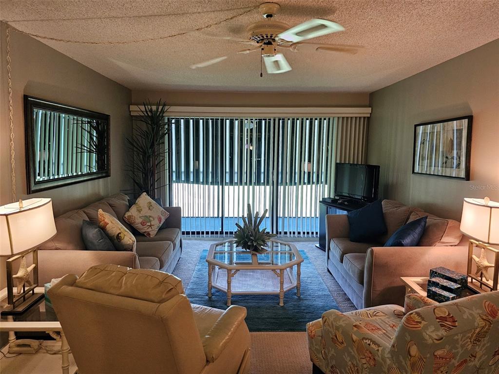 4119 61st Ave Terrace West, Unit 303 Bradenton, FL 34210 - Photo 4 of 22 a living room with furniture or couch and a window
