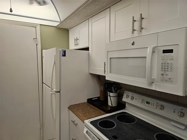 a kitchen with stainless steel appliances cabinets and a counter top space