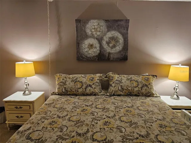 a bedroom with a bed and a lamp