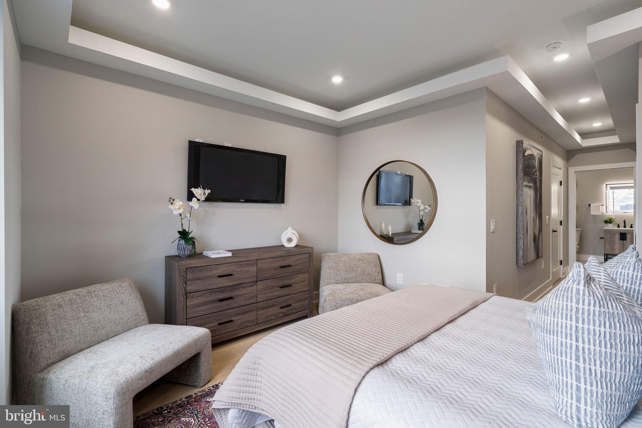 717 Mercy Street Philadelphia, PA 19148 - Photo 19 of 48 a bedroom with a bed a mirror and lamp