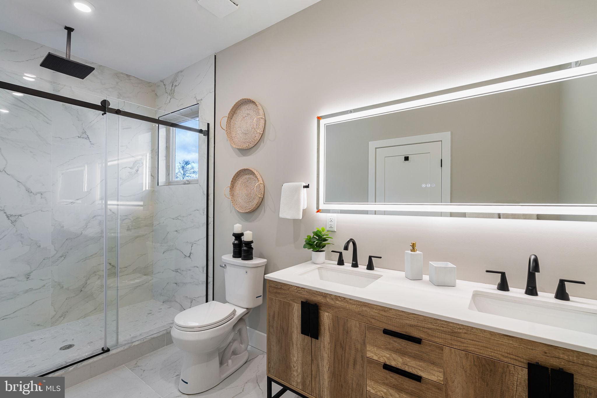 717 Mercy Street Philadelphia, PA 19148 - Photo 21 of 48 a bathroom with a granite countertop sink mirror vanity and toilet