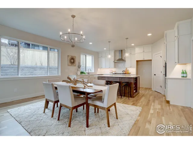 a view of a dining room with furniture and a chandelier