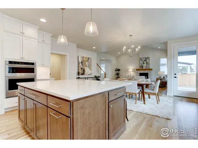 a kitchen with kitchen island a stove a table and chairs