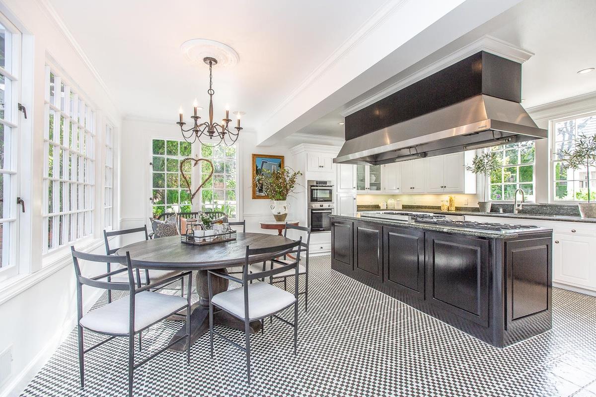 863 Chiltern Road Hillsborough, CA 94010 - Photo 15 of 50 a kitchen with stainless steel appliances granite countertop a stove a sink dishwasher a dining table and chairs with wooden floor