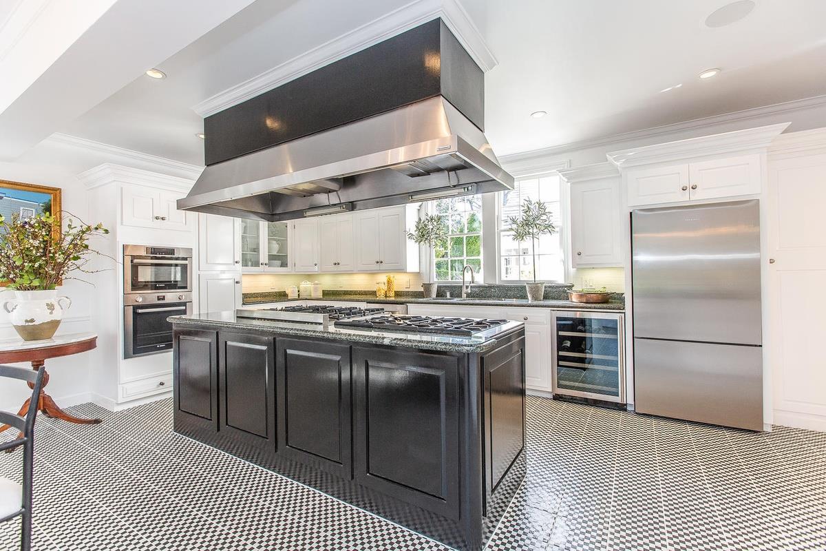 863 Chiltern Road Hillsborough, CA 94010 - Photo 16 of 50 a kitchen with stainless steel appliances granite countertop a stove and a refrigerator