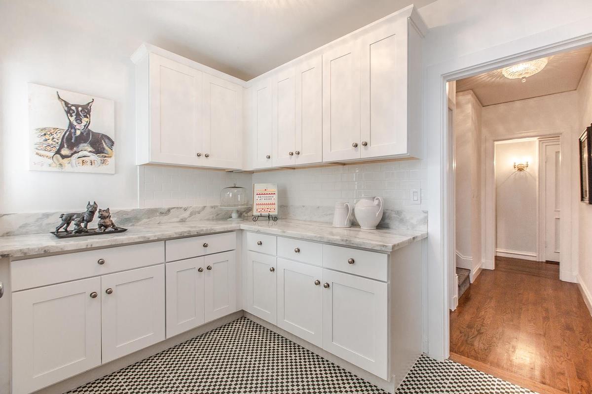 863 Chiltern Road Hillsborough, CA 94010 - Photo 18 of 50 a kitchen with granite countertop white cabinets and sink