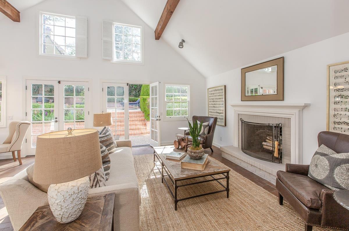 863 Chiltern Road Hillsborough, CA 94010 - Photo 22 of 50 a living room with furniture fireplace and large windows