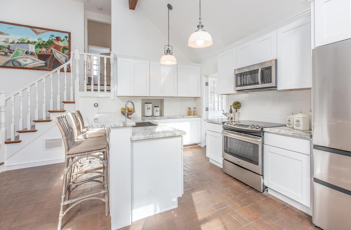 863 Chiltern Road Hillsborough, CA 94010 - Photo 23 of 50 a kitchen with a white cabinets and white appliances