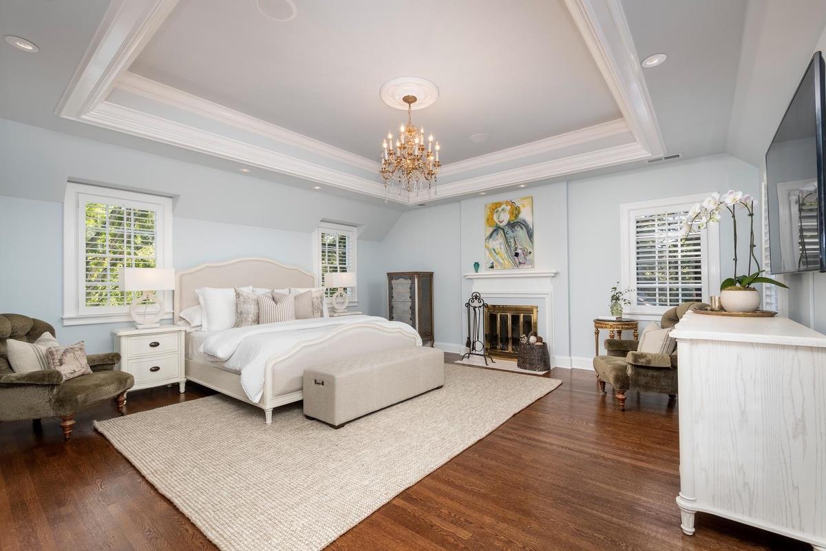 863 Chiltern Road Hillsborough, CA 94010 - Photo 25 of 50 a spacious bedroom with a bed and a fireplace