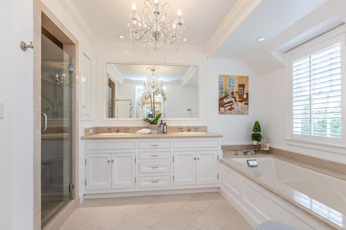 863 Chiltern Road Hillsborough, CA 94010 - Photo 29 of 50 a bathroom with a granite countertop sink a large mirror and a bathtub