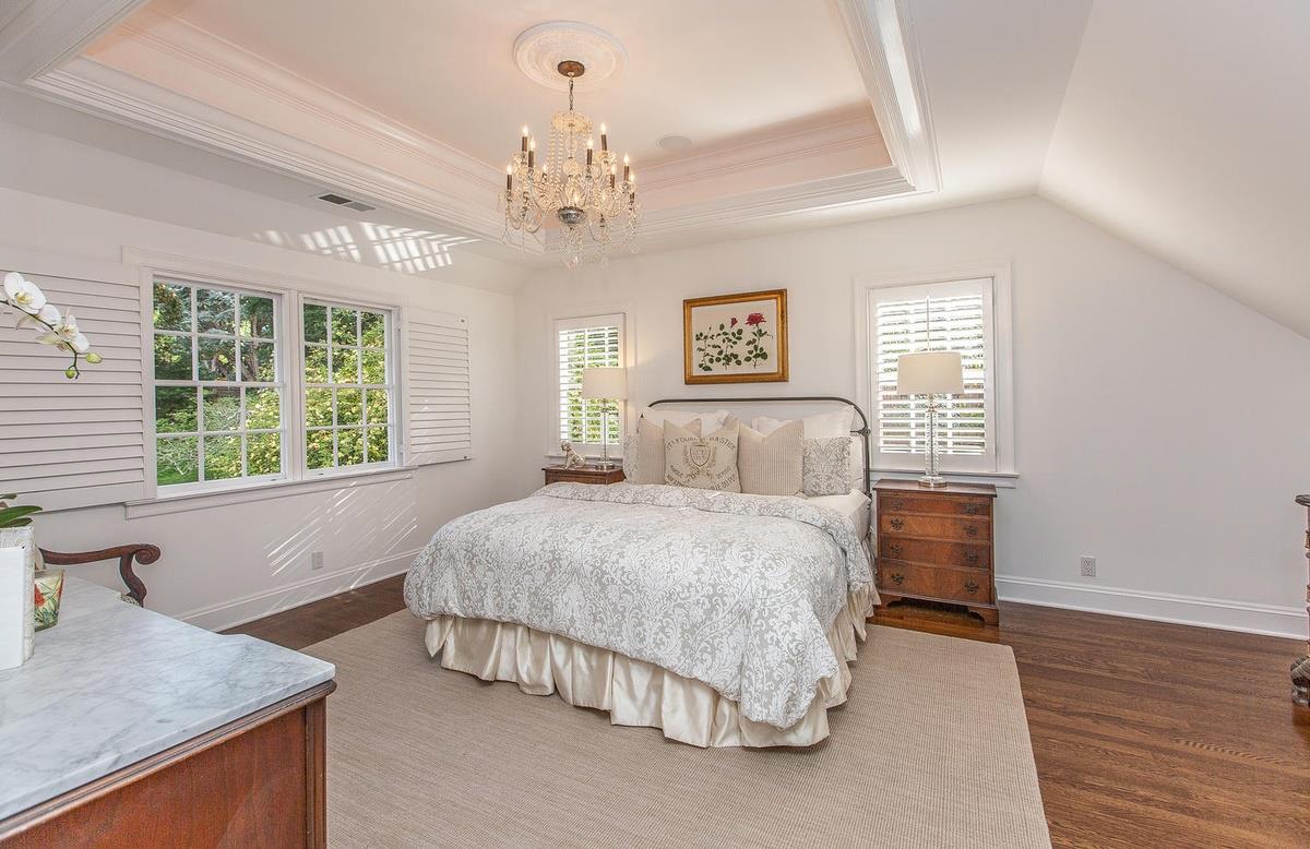 863 Chiltern Road Hillsborough, CA 94010 - Photo 30 of 50 a spacious bedroom with a large bed and a chandelier