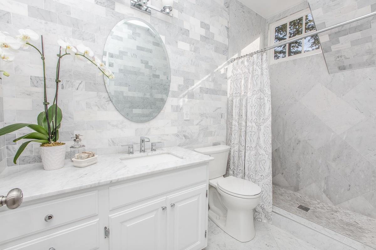 863 Chiltern Road Hillsborough, CA 94010 - Photo 35 of 50 a bathroom with a sink a toilet and a mirror