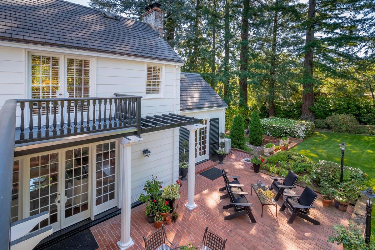 863 Chiltern Road Hillsborough, CA 94010 - Photo 39 of 50 a view of a chair and tables in the back yard of the house